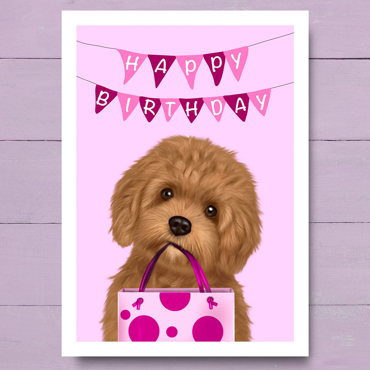 Birthday card with Cavapoo holding Pink gift bag