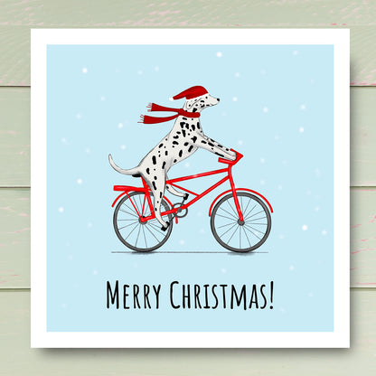 Dalmatian riding bike in the snow with Santa hat. illustrated by Kitty's Art